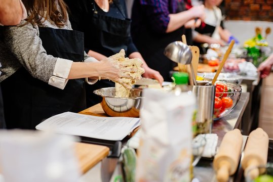 Woman preparing dough in the bowl.