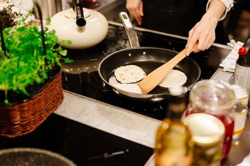 Woman frying tortilla wraps