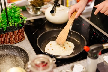 Woman frying tortilla wraps