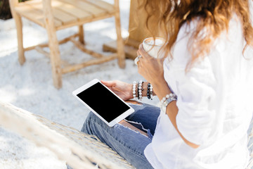 Hipster woman hands holding digital tablet with empty blank screen for your text message, business person browsing internet or connecting to wireless via touchscreen pad