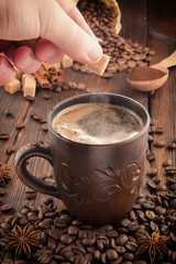 clay cup with coffee on the background of grains