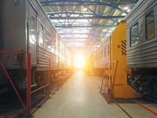 Passenger cars wagoon locomotive on repair in depots of railways, hangar view.