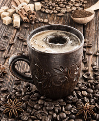 clay cup with coffee on the background of grains
