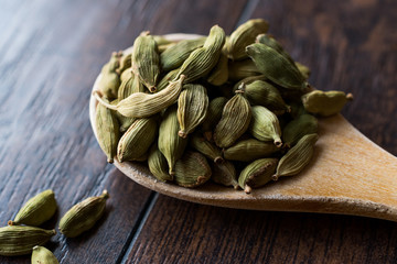 Cardamom Seeds in Wooden Spoon.