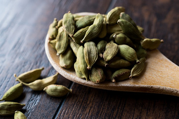 Cardamom Seeds in Wooden Spoon.