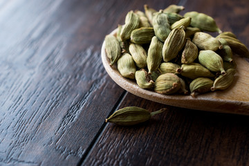 Cardamom Seeds in Wooden Spoon.