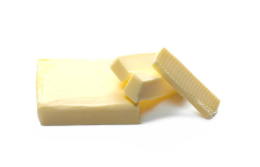 Yellow butter pieces isolated on white background