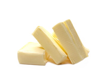 Yellow butter pieces isolated on white background