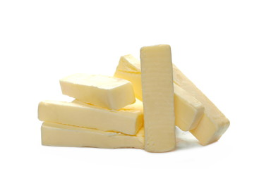 Yellow butter pieces isolated on white background