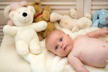 Baby boy and white teddy bear. Childhood and innocence concept.