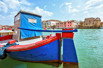 Fototapeta na wymiar Daylight view to vibrant colorful blue and red boat parked in Ve
