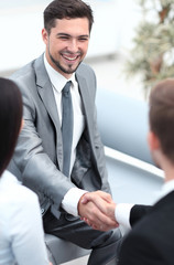 handshake business partners in the lobby of the office.