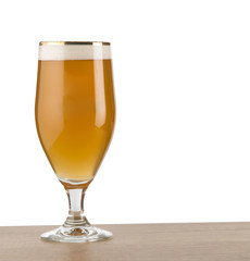 Craft beer in glass on wooden table isolated on white