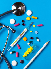 Pills Doctor stethoscope medical tools phonendoscope.Medicine blue background. Doctor's tools
