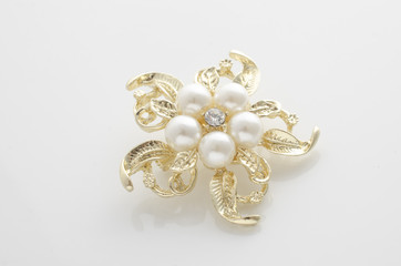 gold brooch flower with pearl isolated on white