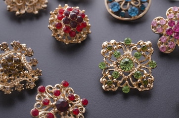 set of brooches isolated on black. background of many brooches