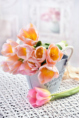 bunch of tulips in vintage style metal pot