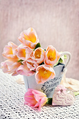 bunch of tulips in vintage style metal pot