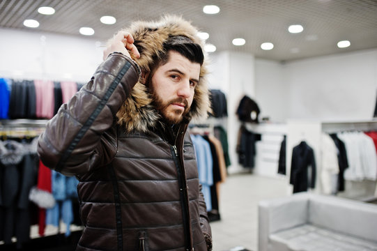 Stylish turkish man at the store of fur coats and leather jackets. Successful arabian beard man.