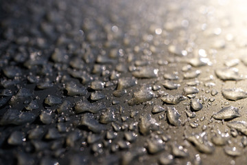frozen water droplets on an iron surface illuminated from above