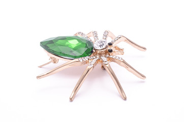 Golden spider with a big green stone isolated on white - 195317187