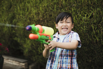 Little boy Enjoying a Garden Water Fight