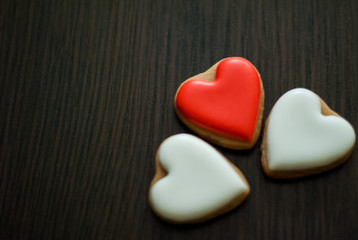 Homemade cookies in the form of heart on a wooden background. There is space for text