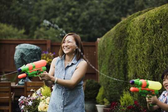 Family Water Fight In The Garden