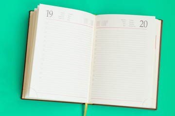 open notebook on green background