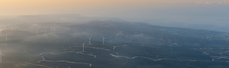 aerial morning view landscape of the Greek side of Cyprus; showing windmill farm on hills near Archimandrita