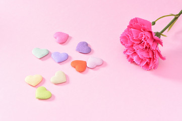 May Mother's Day Carnation Bunch of Flowers Bouquet with colorful heart shape stones Top View, Blank for Text, Pink