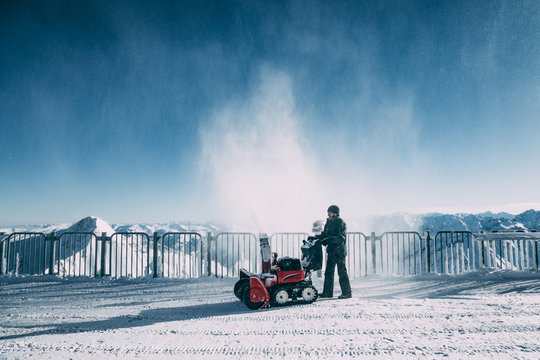 MAYRHOFEN, AUSTRIA - FEBRUARY 19, 2018: Man working with snow blowing machine in mayrhofen ski area, austria