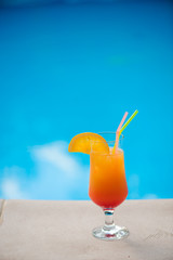 Cocktail next to swimming pool, summer vacation concept