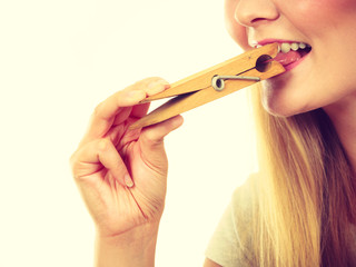 Blonde woman having tongue in clothespin