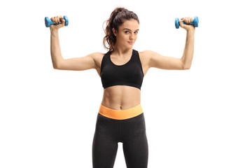 Fototapeta na wymiar Fitness woman exercising with small dumbbells