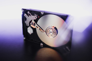 Disassembled hard drive from the computer, hdd with mirror effect. Opened hard drive from the...