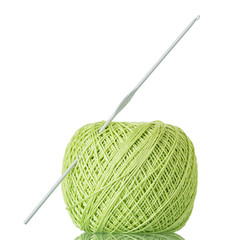 Ball of thread and crochet hook for manual knitting isolated on white
