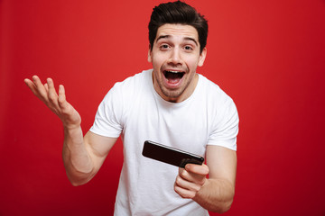 Portrait of a cheerful young man in white t-shirt