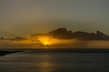 Dark rain cloud and rain at sunrise over the Atlantic Ocean