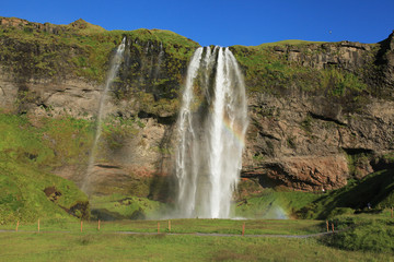Rainbow and waterfall Seljalandsfoss in Iceland