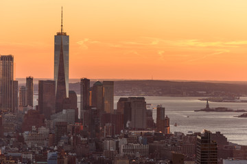 Naklejka premium New York City - USA. View to Lower Manhattan downtown skyline with famous Empire State Building and One World Center and skyscrapers at sunset.