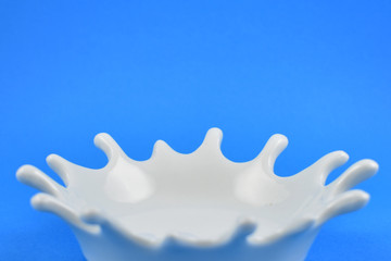 White splash on blue background frame stock photo images. White splash on blue background with copy space for text. White milk drop. White bowl on blue background images