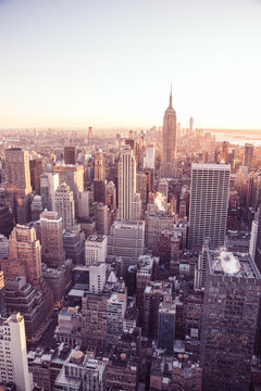 New York City - USA. View to Lower Manhattan downtown skyline with famous Empire State Building and skyscrapers at sunset. © Simon Dannhauer