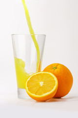 Orange juice pouring into a glass.