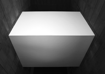 A white cube between two walls