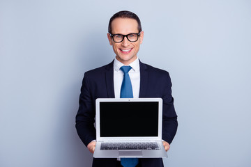 Tie type choose choice people sale discount keypad keyboard try use test person look concept. Portrait of excited smart glad manager holding giving netbook place for text  isolated on gray background