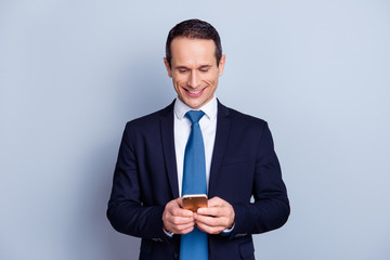 Pause break time modern people person entertainment concept. Portrait of excited careless handsome funky rejoicing  employer using cell for watching videos isolated on gray background copy-space