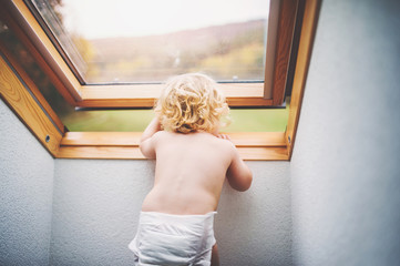 Toddler boy in a dangerous situation at home.