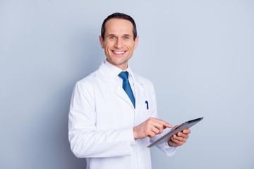 Device science wellness laptop research people person concept. Portrait of cheerful glad gifted smart with toothy smile doctor using modern pad at work isolated on gray background copy-space