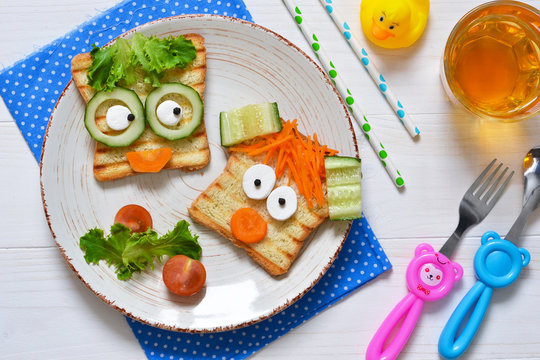 Breakfast for a child - children's funny toasts with a grilled and carrot.